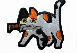Detailed embroidery texture of a cute calico cat holding a knife tactical morale patch