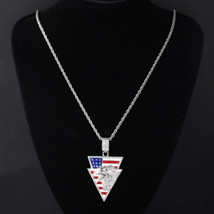 Detail of silver cuban chain with rhinestone eagle and American flag pendant