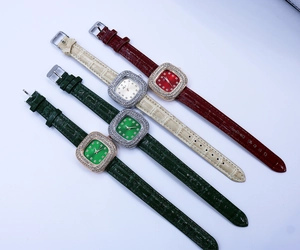 Detail of luxury square quartz watches with diamond bezels and leather straps in four colors