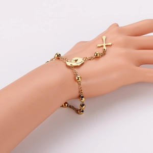 Golden bead bracelet with palm and cross charms on a model, stainless steel jewelry piece