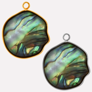 Macro detail of oval abalone shell pendants with gold and silver stainless steel frames