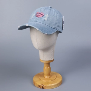 Distressed denim baseball cap with pink CUHD embroidery and vintage ripped details