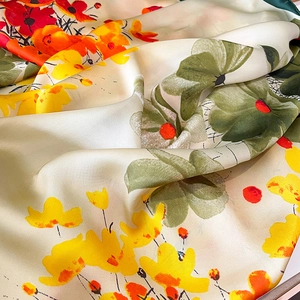 Elegant floral silk scarf with vibrant orange and yellow flowers on a cream background