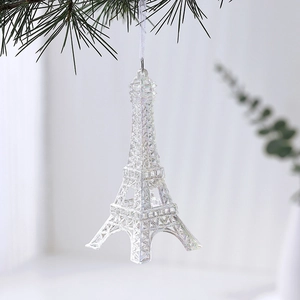Iridescent Eiffel Tower acrylic ornament hanging on a pine branch for Christmas decor