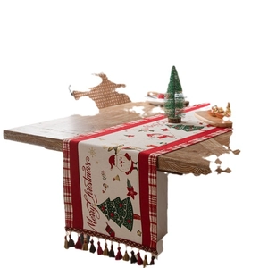 Christmas table runner with red plaid patterns, snowman motifs and decorative tassels