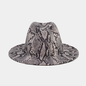 Close-up of wide-brimmed fedora hat with elegant grey snakeskin print and wool texture