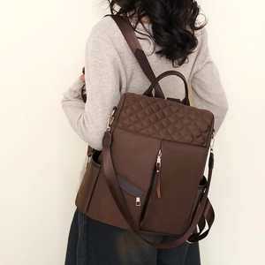 Deep brown nylon backpack for women featuring stylish diamond quilted stitching and metal zippers