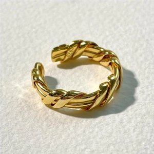 Close-up of golden S925 sterling silver open ring with twisted rope texture detail
