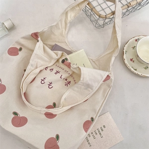 Close-up of peach print canvas tote bag with taste of peaches lettering