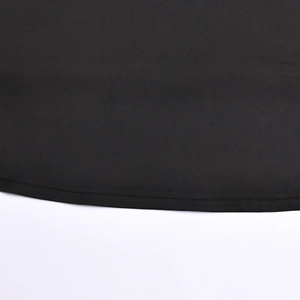 Close-up of black fabric hemline with precise stitching on a two-piece skirt set