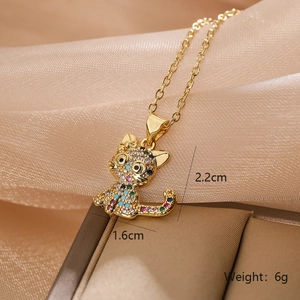 Detail of a colorful zircon cat pendant necklace resting on a premium brown jewelry box