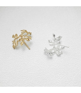 Detailed view of leaf-shaped metal hair hooks in gold and silver finishes