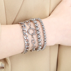 Minimalist silver stacked bracelet set featuring cuban link and beaded metal chains for women