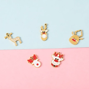 Five assorted Christmas reindeer pendants in 18K gold plated metal with enamel details