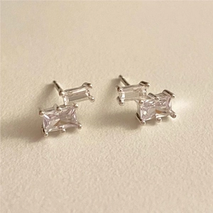 Macro detail of 925 sterling silver square zircon stud earrings with staggered design