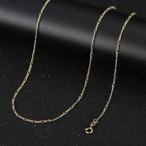 Detail of a golden S925 sterling silver Figaro chain necklace with a spring ring clasp