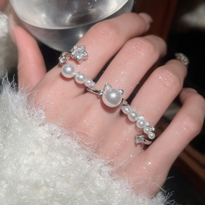 Detail of silver pearl ring with star zircon and cat ear pearl on hand