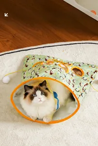Cat tunnel toy with green hedgehog print and orange edges featuring a white plush pompom