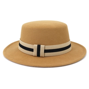 Detail of camel flat-top wool fedora hat featuring a classic striped ribbon band decoration