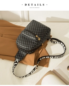 Close-up of retro geometric pattern chest bag with colorful wide strap and gold zipper