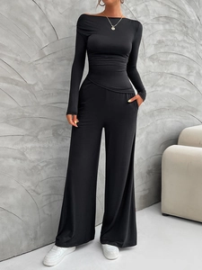 Detail view of women's Y2K two-piece set featuring a black slim long-sleeve top and wide-leg pants