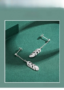 Macro detail of S925 sterling silver long leaf earrings with delicate fringe texture