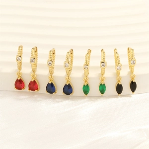 Close-up of 18K gold earrings with colorful zircon in drop and marquise cuts