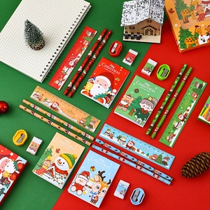 Festive Christmas stationery set with pencils, rulers, and notebooks for kids' gifts.