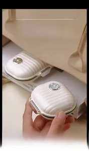 Mini portable cream-colored pill box with suitcase texture and silver metal lock