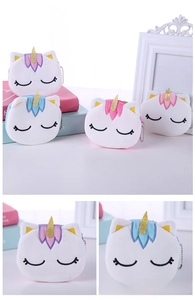 Detailed close-up of unicorn plush coin purse with gold horn and embroidered closed eyes