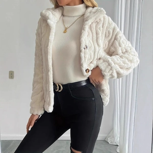 Close-up of cream double-sided plush jacket featuring intricate cable knit texture details