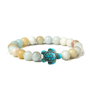 Close-up of elastic bracelet with natural stone beads and blue sea turtle charm