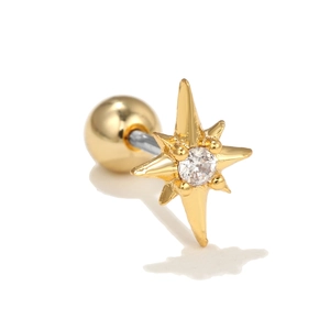 Detailed macro view of gold starburst ear stud with clear zircon and screw ball back
