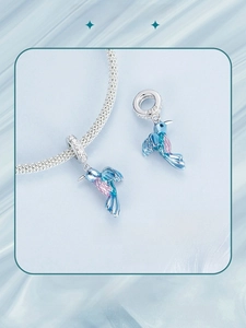 Detail of 925 sterling silver kingfisher charm with blue and pink gradient enamel
