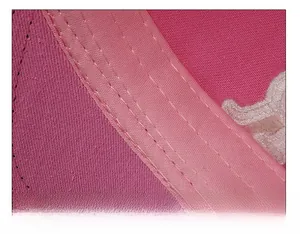 Macro shot of pink baseball cap inner sweatband with reinforced stitching details