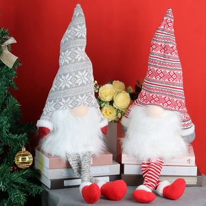 Set of two Christmas forest gnome plush ornaments with knitted hats on a cozy holiday backdrop