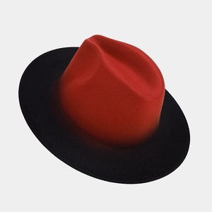 Detail of red and black gradient wool fedora hat with wide brim and smooth color transition