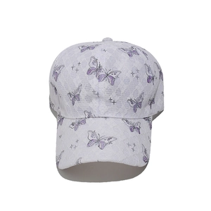 Detail of white lace baseball cap featuring elegant purple butterfly and star embroidery