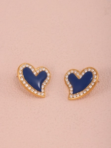 Detail of heart-shaped earrings with blue enamel and sparkling white rhinestones