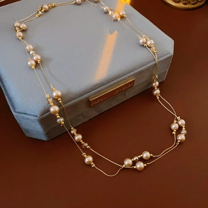 Macro detail of French vintage double-layer necklace with champagne pearls and crystals