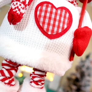 Detailed view of knitted fabric and plush texture on a Christmas doll decoration