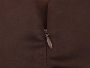 Detail of invisible zipper closure and fine twill texture on brown halter neck dress
