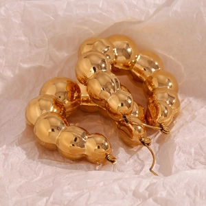 Detail shot of hollow bubble-textured earrings in 18K gold plated stainless steel