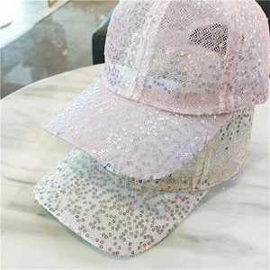 Detail of pink and champagne gold sequins on stylish mesh baseball caps with reflective finish