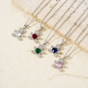 Sparkling zircon bear heart necklaces in five colors on natural stone background