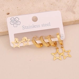 Detail of gold stainless steel earring set featuring star studs and polished hoops