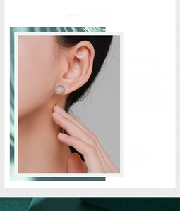 Detailed view of silver hexagonal stud earring with turquoise inlay and sparkling crystals
