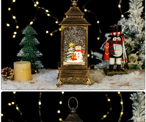 Lanterne de Noël vintage en bronze avec scène de bonhomme de neige et paillettes à l'intérieur