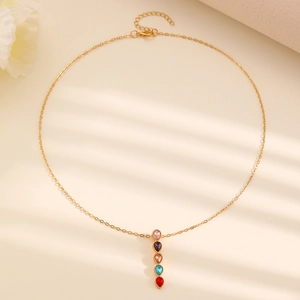 Detail of gold chain necklace featuring five vertical colorful teardrop zircon pendants