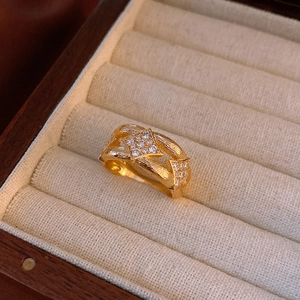 Detail of vintage gold brushed ring with zircon diamonds in a luxury jewelry box